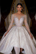 TheBlissWedding ball gown wedding dress with long sleeves, intricate hand-beaded sequin details, and a scoop neckline.