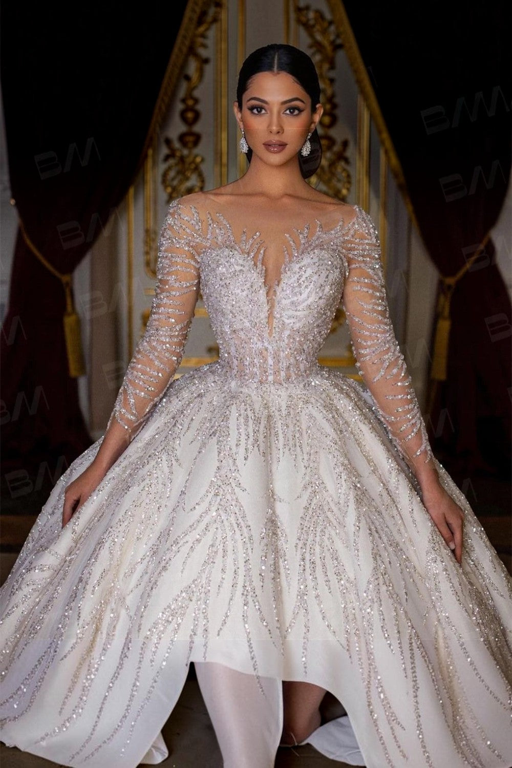 TheBlissWedding ball gown wedding dress with long sleeves, intricate hand-beaded sequin details, and a scoop neckline.