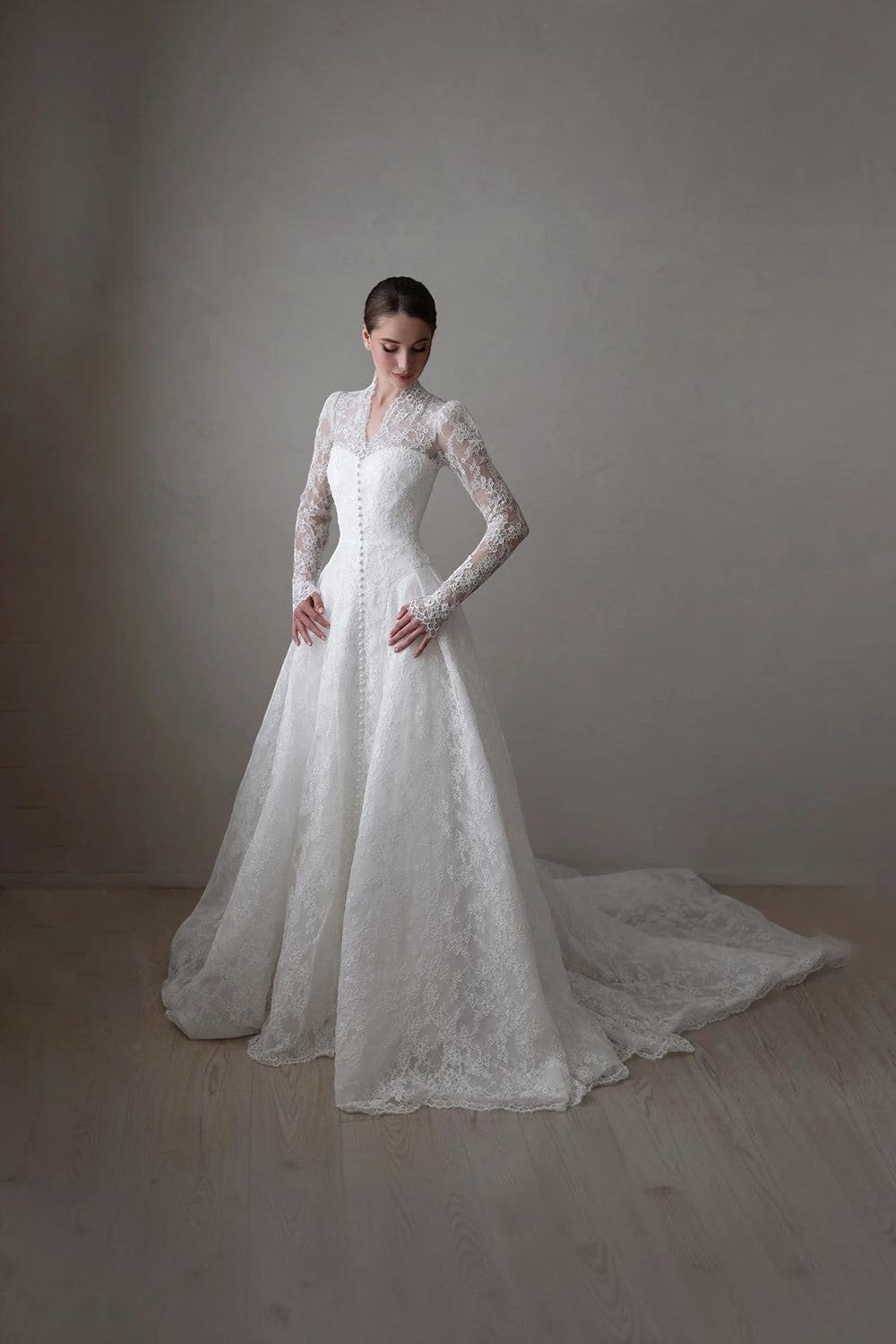 TheBlissWedding lace A-line bridal gown with high collar, long illusion sleeves, and a graceful sweep train.