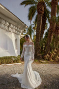 TheBlissWedding white off-shoulder mermaid wedding dress with long lace sleeves, pearl beading, and a sweep train.