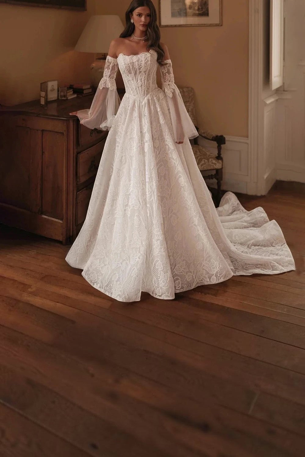 TheBlissWedding off shoulder lace A-line bridal gown with detachable flare sleeves and a sweep train in ivory.
