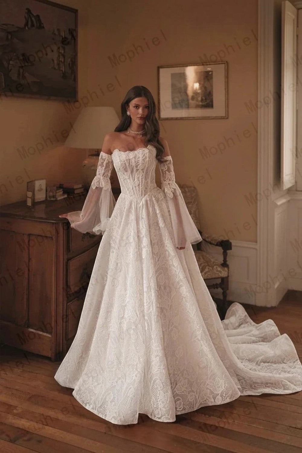 TheBlissWedding off shoulder A-line bridal gown with intricate lace, detachable flare sleeves, and a sweep train.