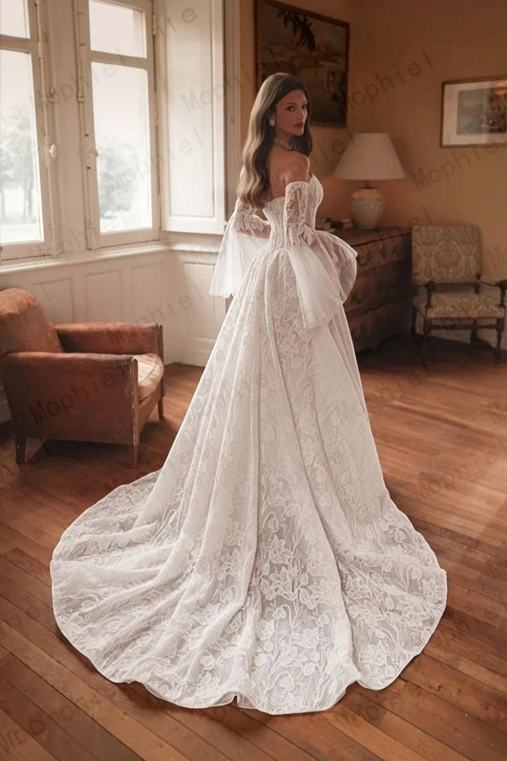 TheBlissWedding off shoulder A-line bridal gown with intricate lace, detachable flare sleeves, and a sweep train.