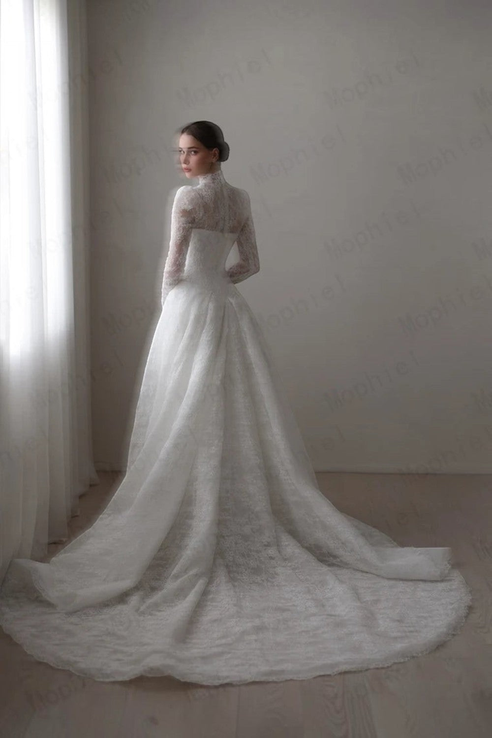 TheBlissWedding lace wedding dress with high collar, long illusion sleeves, and A-line skirt with a sweep train.
