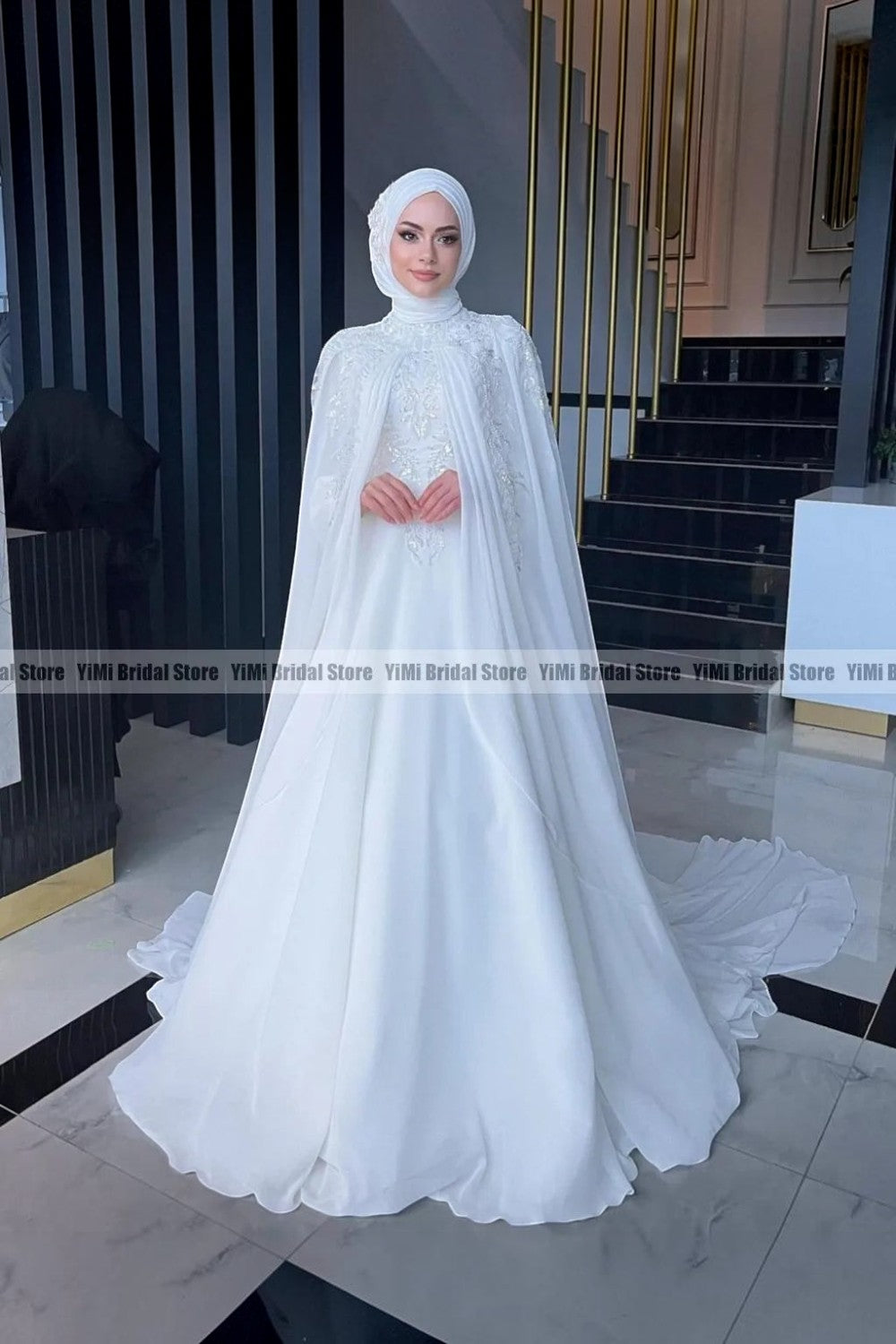TheBlissWedding modest white chiffon bridal gown with high neck, long sleeves, pearl details, and matching hijab.