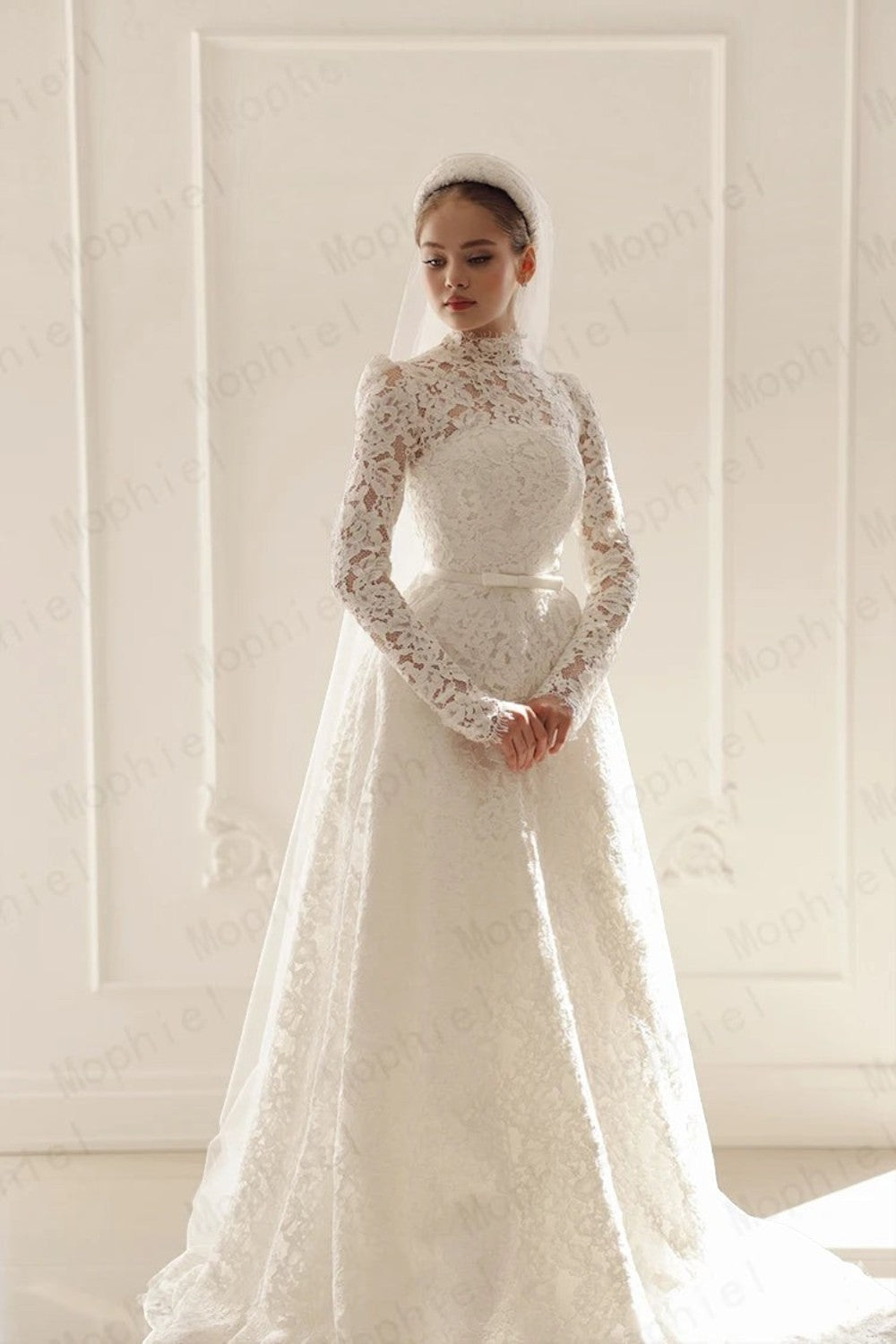 TheBlissWedding modest white lace wedding dress with high neck, long sleeves, and A-line silhouette with a veil.
