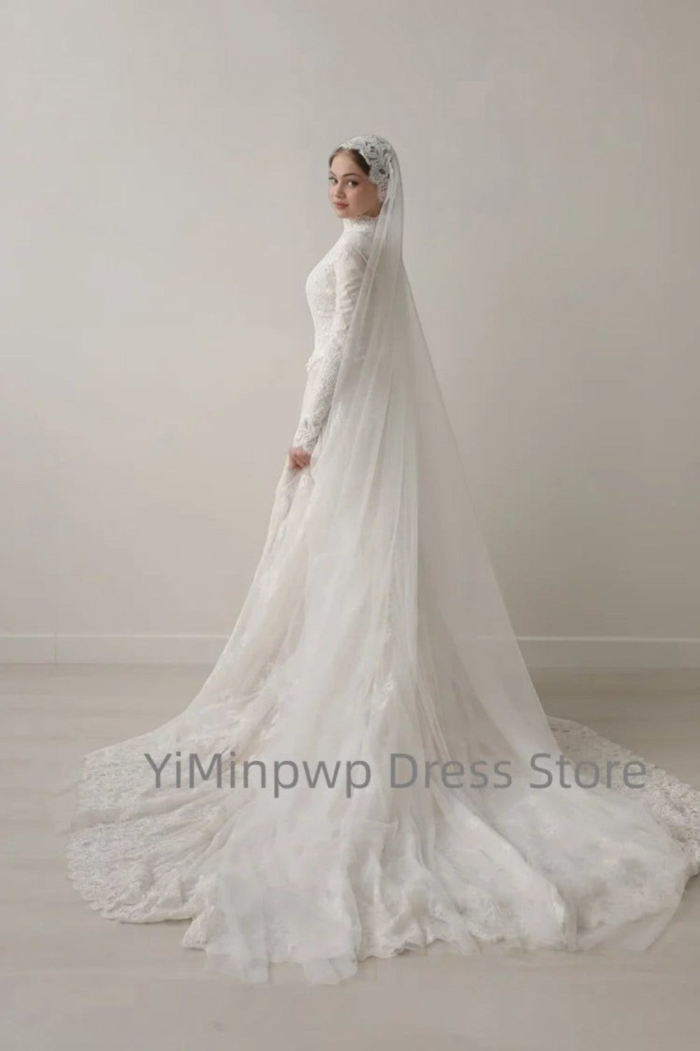 TheBlissWedding white modest A-line wedding dress with high collar, long lace sleeves, and a long flowing sweep train.