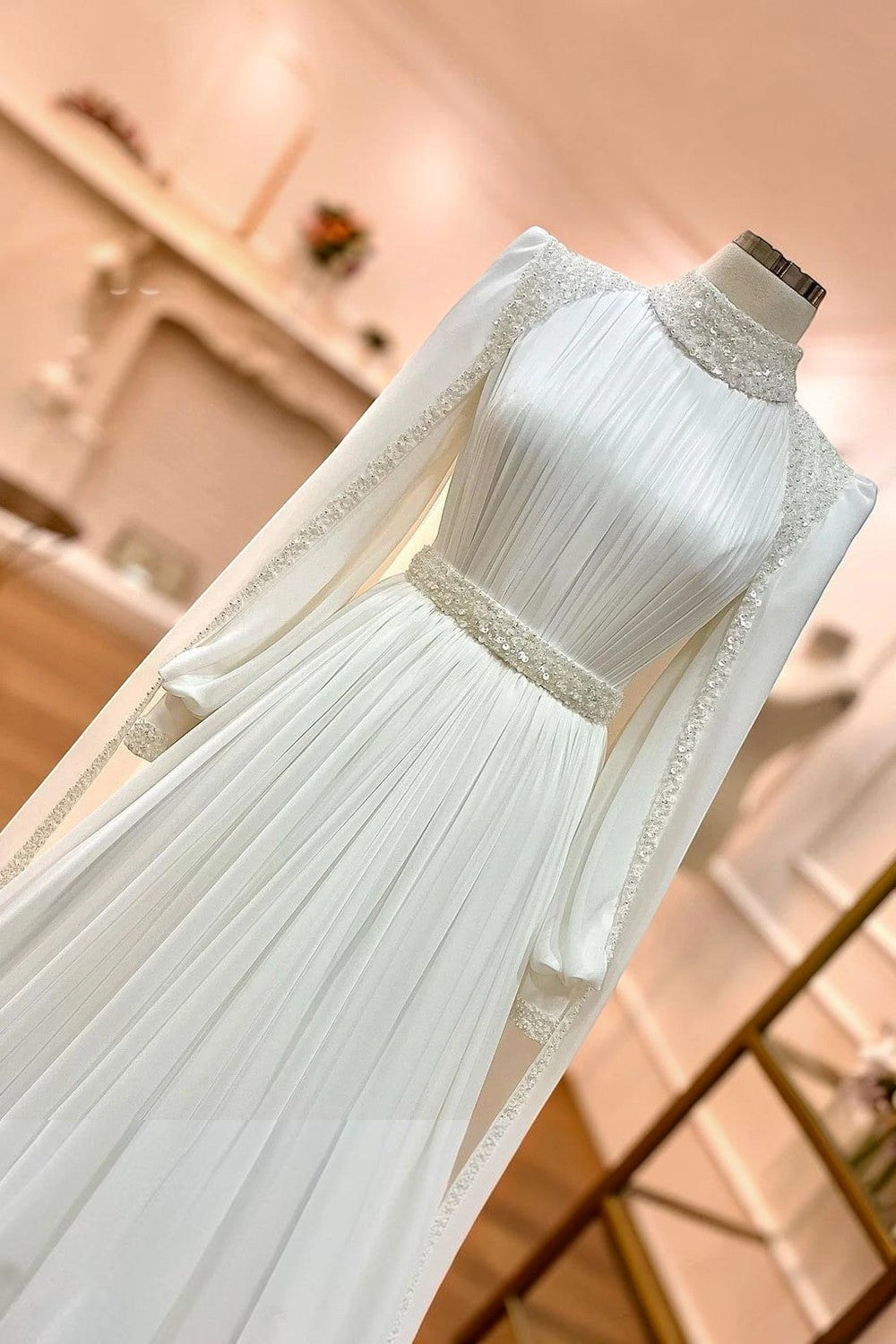 TheBlissWedding modest A-line wedding dress in white satin with high collar, long sleeves, and sequin embellishments.