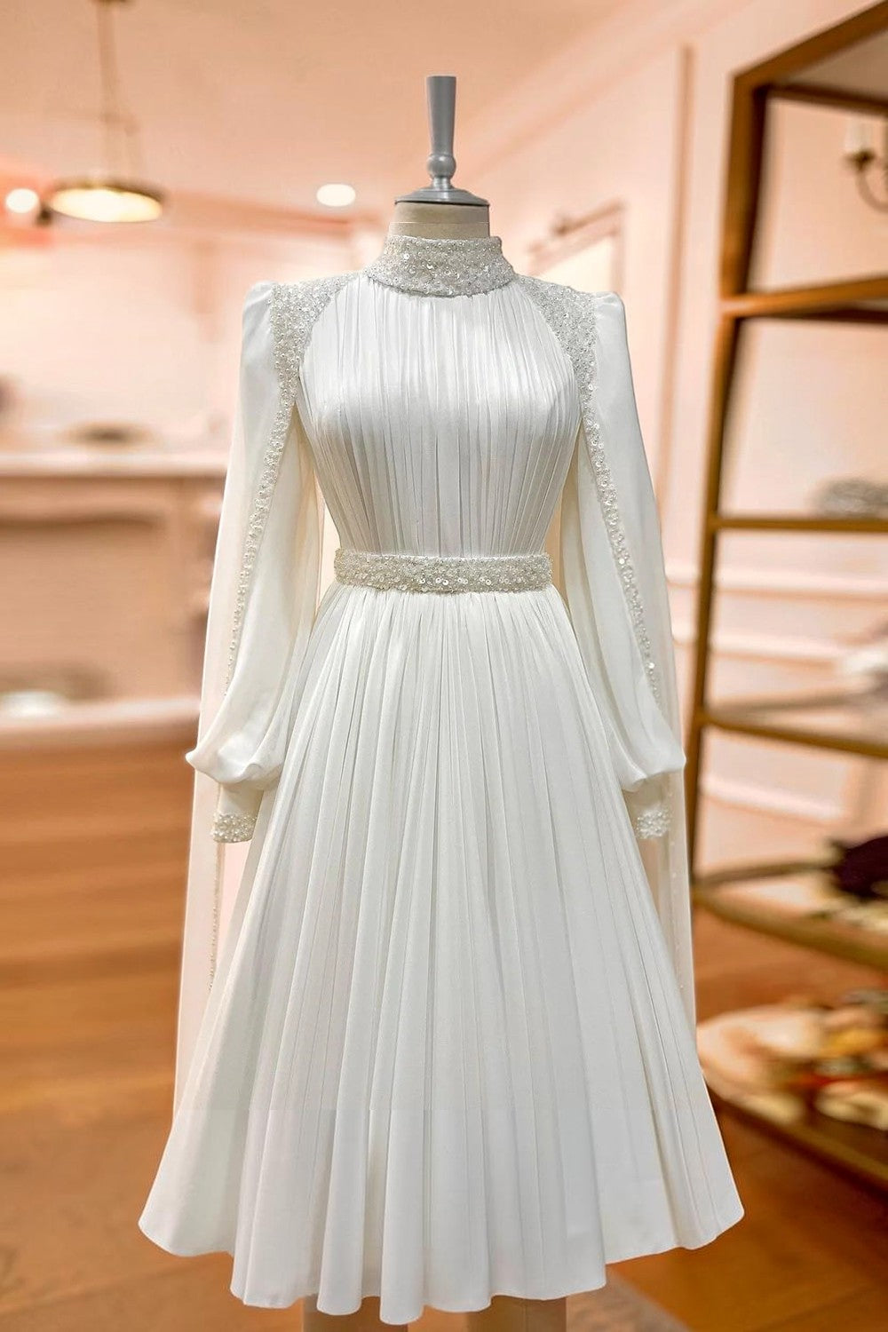 TheBlissWedding modest A-line wedding dress in white satin with a high collar, long sleeves, and sequin detailing.