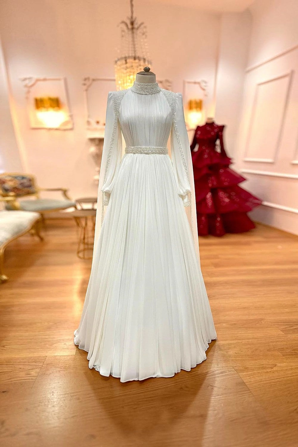 TheBlissWedding modest white A-line wedding dress with high collar, long sleeves, and sequin waist detailing.