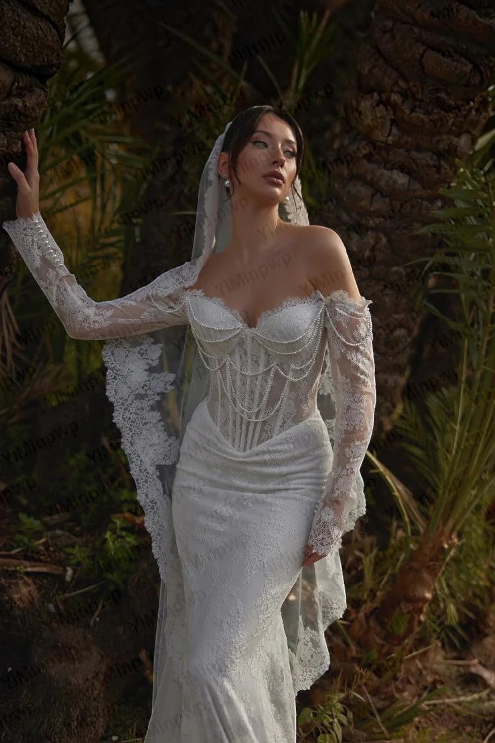 TheBlissWedding off-shoulder mermaid bridal gown with long lace sleeves, pearl draping, and sweetheart corset bodice.