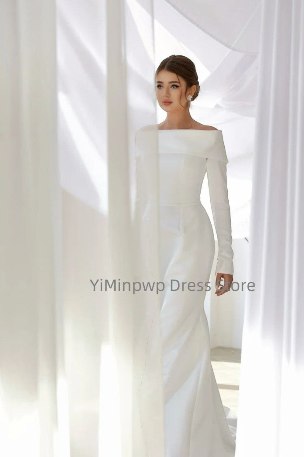 TheBlissWedding white satin mermaid wedding dress with off-shoulder neckline and long sleeves on a model