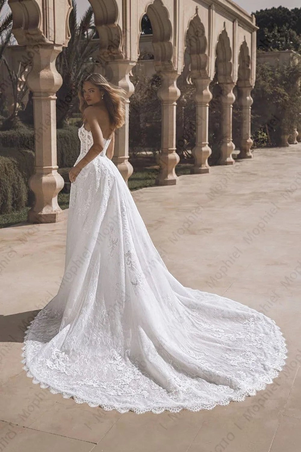 TheBlissWedding strapless mermaid bridal gown with intricate lace appliques and a dramatic detachable train