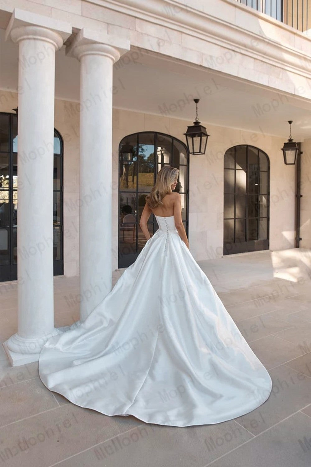 TheBlissWedding strapless white satin A-line wedding dress with a sweep train and button-back detail on a bride.