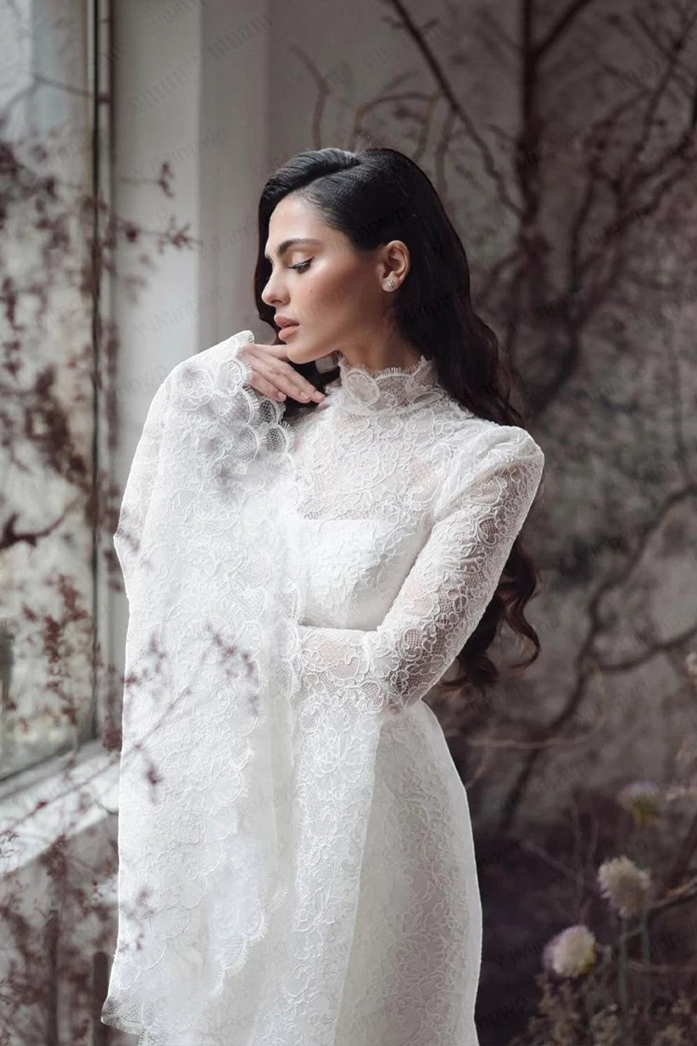 TheBlissWedding white boho wedding dress with high neck, intricate lace, and dramatic long flare sleeves
