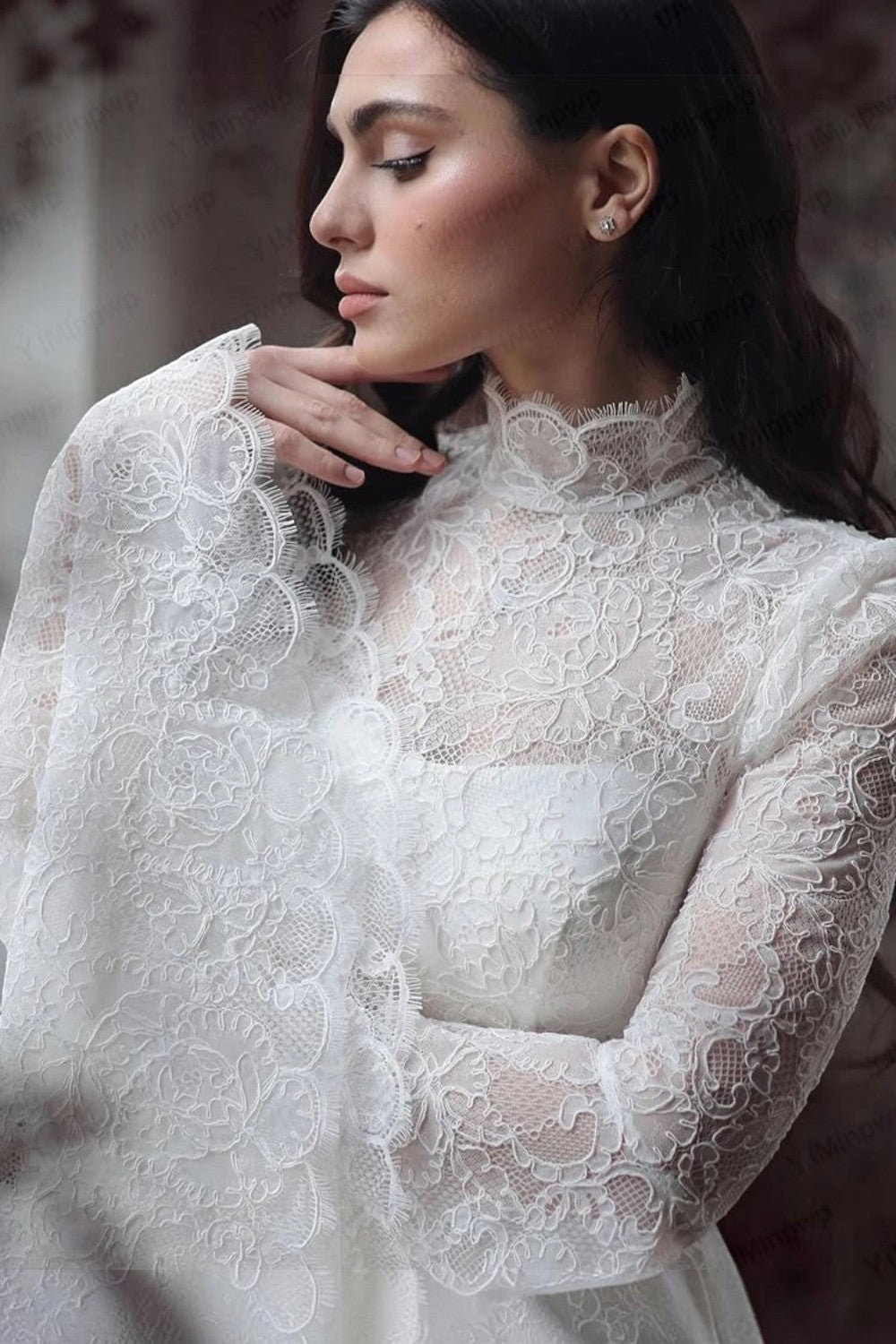 TheBlissWedding white lace boho wedding dress featuring a high neck and long flare sleeves with intricate detailing.