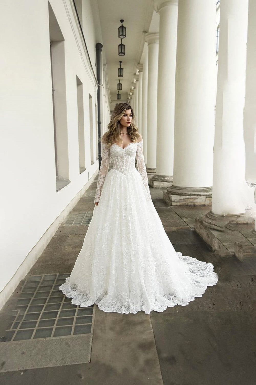 TheBlissWedding white lace A-line bridal gown with off-shoulder neckline, long sleeves, and a dramatic floor-length train.